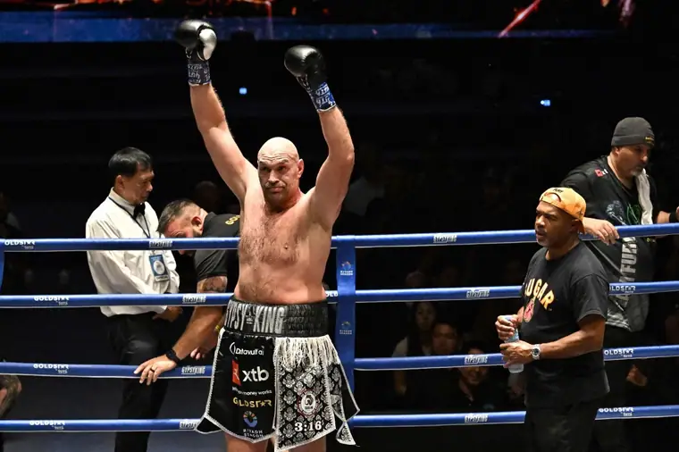 Tyson Fury raising both gloves in the ring